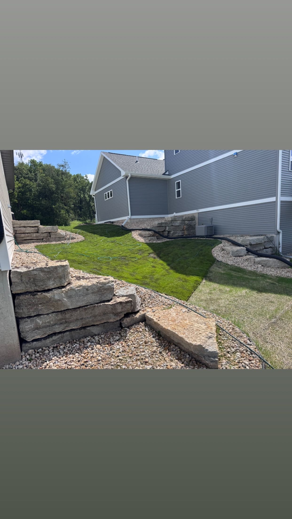 Curved stone retaining walls with new sod