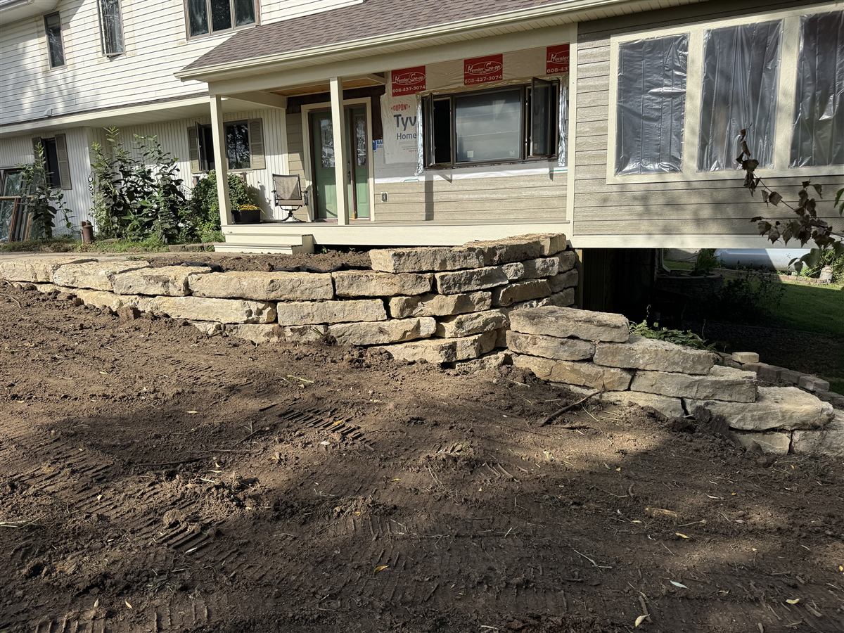 Natural stone retaining wall under construction